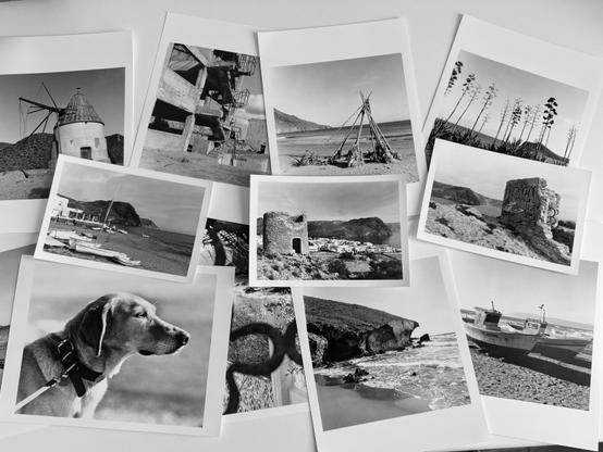 Black and w.hite darroon prints scattered on a worktop
