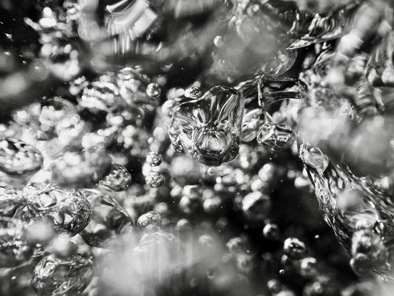 Shiny silver air bubbles, formed where water has poured into a pool over rocks after heavy rain, look like shape-shifting blobs of mercury. Within moments of forming, they are gone, like a fleeting thought. This photograph is proof that they existed, however briefly.