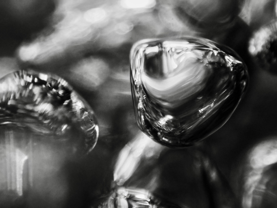 Shiny silver air bubbles, formed where water has poured into a pool over rocks after heavy rain, look like shape-shifting blobs of mercury. Within moments of forming, they are gone, like a fleeting thought. This photograph is proof that they existed, however briefly.