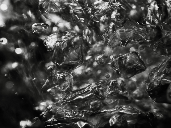 Shiny silver air bubbles, formed where water has poured into a pool over rocks after heavy rain, look like shape-shifting blobs of mercury. Within moments of forming, they are gone, like a fleeting thought. This photograph is proof that they existed, however briefly.