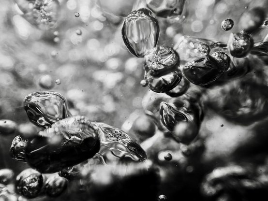 Shiny silver air bubbles, formed where water has poured into a pool over rocks after heavy rain, look like shape-shifting blobs of mercury. Within moments of forming, they are gone, like a fleeting thought. This photograph is proof that they existed, however briefly.