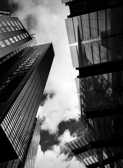 view up to clouds through highrises
